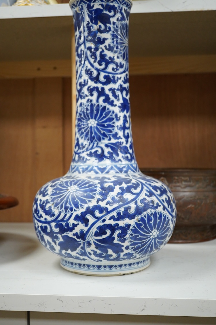 A Chinese blue and white bottle vase with lotus decoration, restored, Kangxi Period, 44cm high